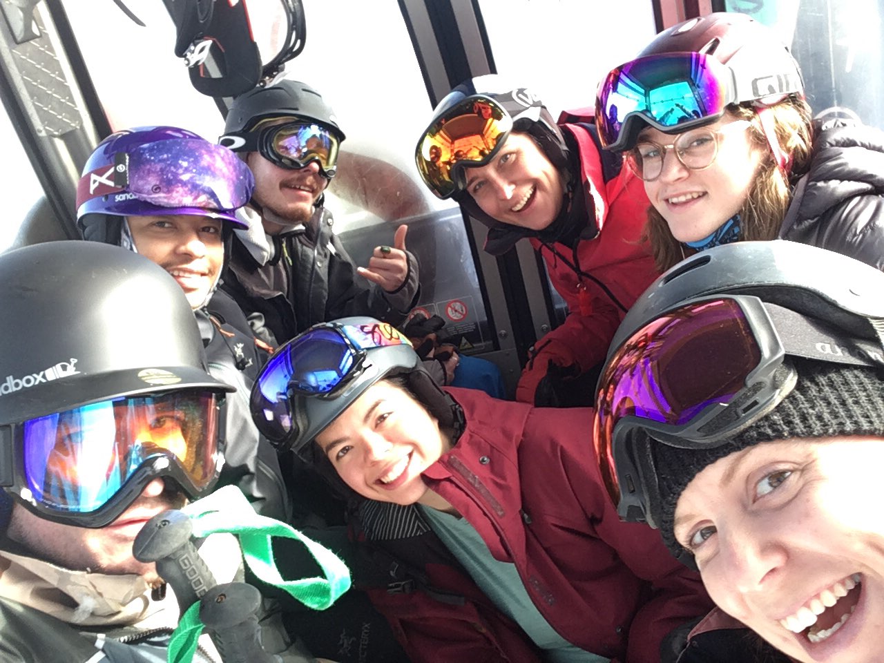 Zero Ceiling youth smiling together while snowboarding