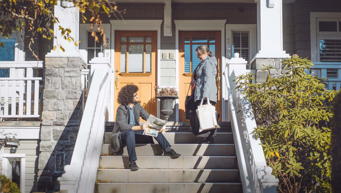 Two people talking on porch steps