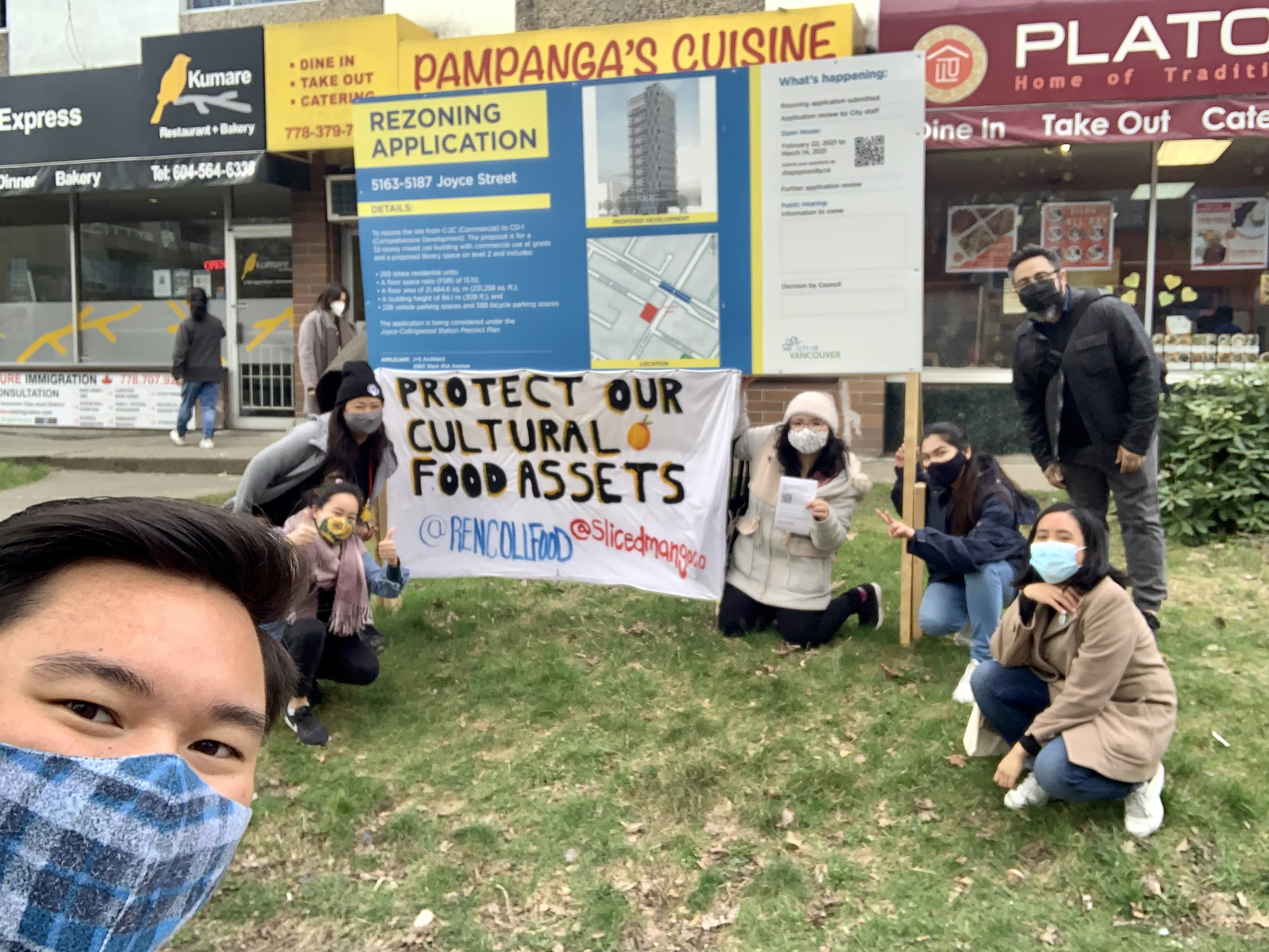 Seven supporters of the #SliceofSupport campaign stand in front of two signs: one saying