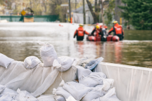 Sandbags and rescue personnel during a flood