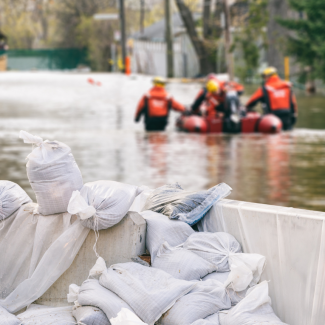 Sandbags and rescue personnel during a flood