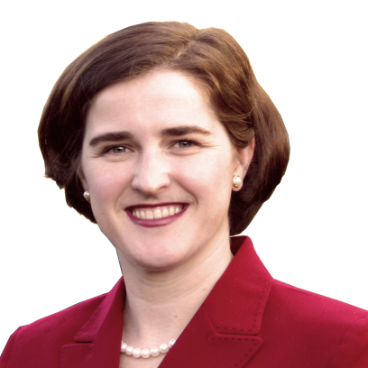 Headshot of Dr. Alexandra Greenhill, a smiling woman with brown hair wearing a red blazer, red lipstick and a pearl necklace and earrings