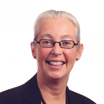 Brenda Eaton Headshot of Brenda Eaton, a smiling woman with light eyes and white hair wearing glasses and a dark purple blazer
