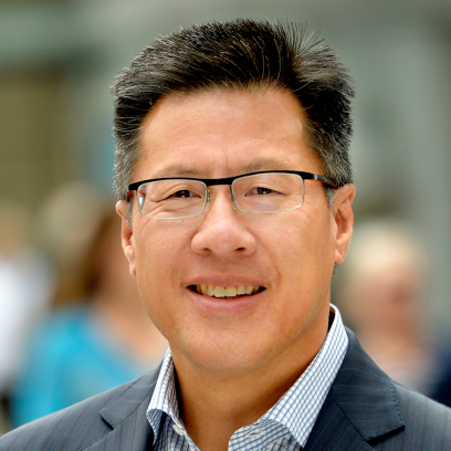 Headshot of Calvin Fong, a smiling man with short salt and pepper dark hair, wearing glasses