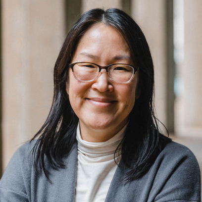 Headshot of Sarah Kim, a smiling woman with long dark hair