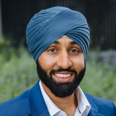 Headshot of Balraj Kalkat, a smiling man with a dark beard, wearing a turban