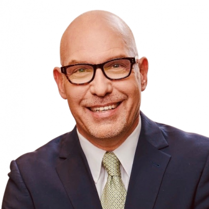 Headshot of Maury Kask. He has light eyes, dark rimmed glasses and a stubble, and is wearing a dark suit and light yellow tie.