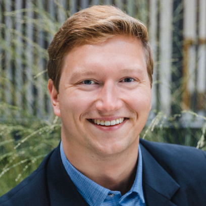 Headshot of Scott Brownlie, a smiling man with short light hair and light eyes