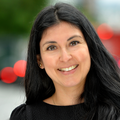 Headshot of Stephanie Falcon. She has hazel eyes and long dark hair, and is wearing a dark top.