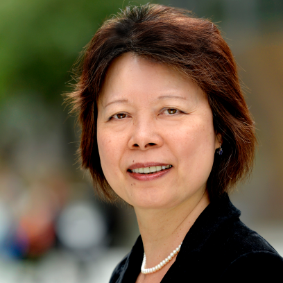 Headshot of Ying Xiao, a smiling woman with short reddish-brown hair and brown eyes