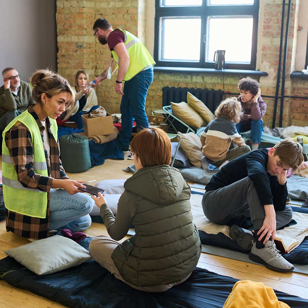 Volunteers helping people seeking refuge in a temporary shelter