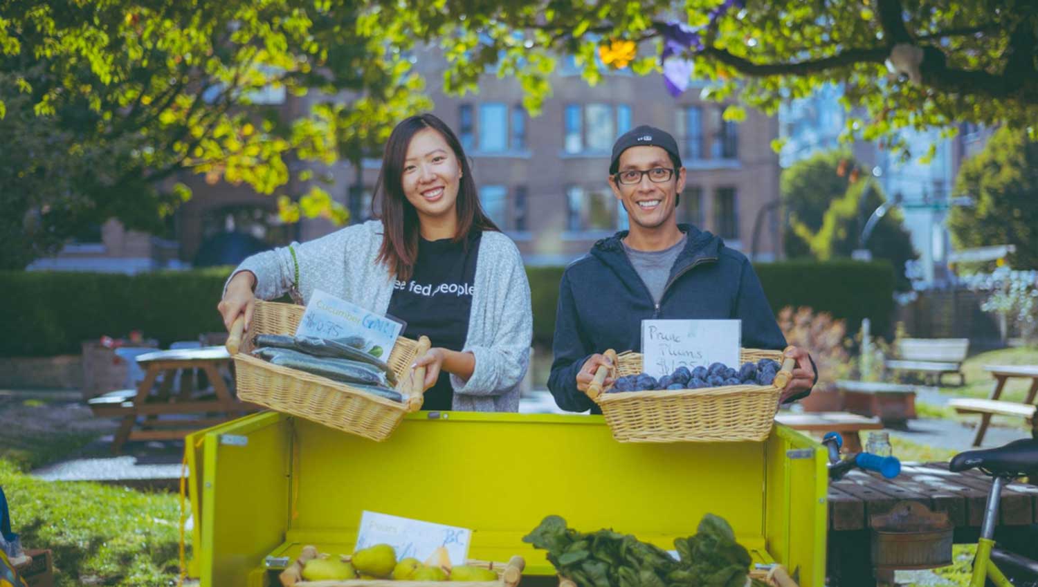 Couple displaying vegetables