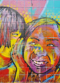 Thumbnail of colourful mural of a child whispering to another smiling child