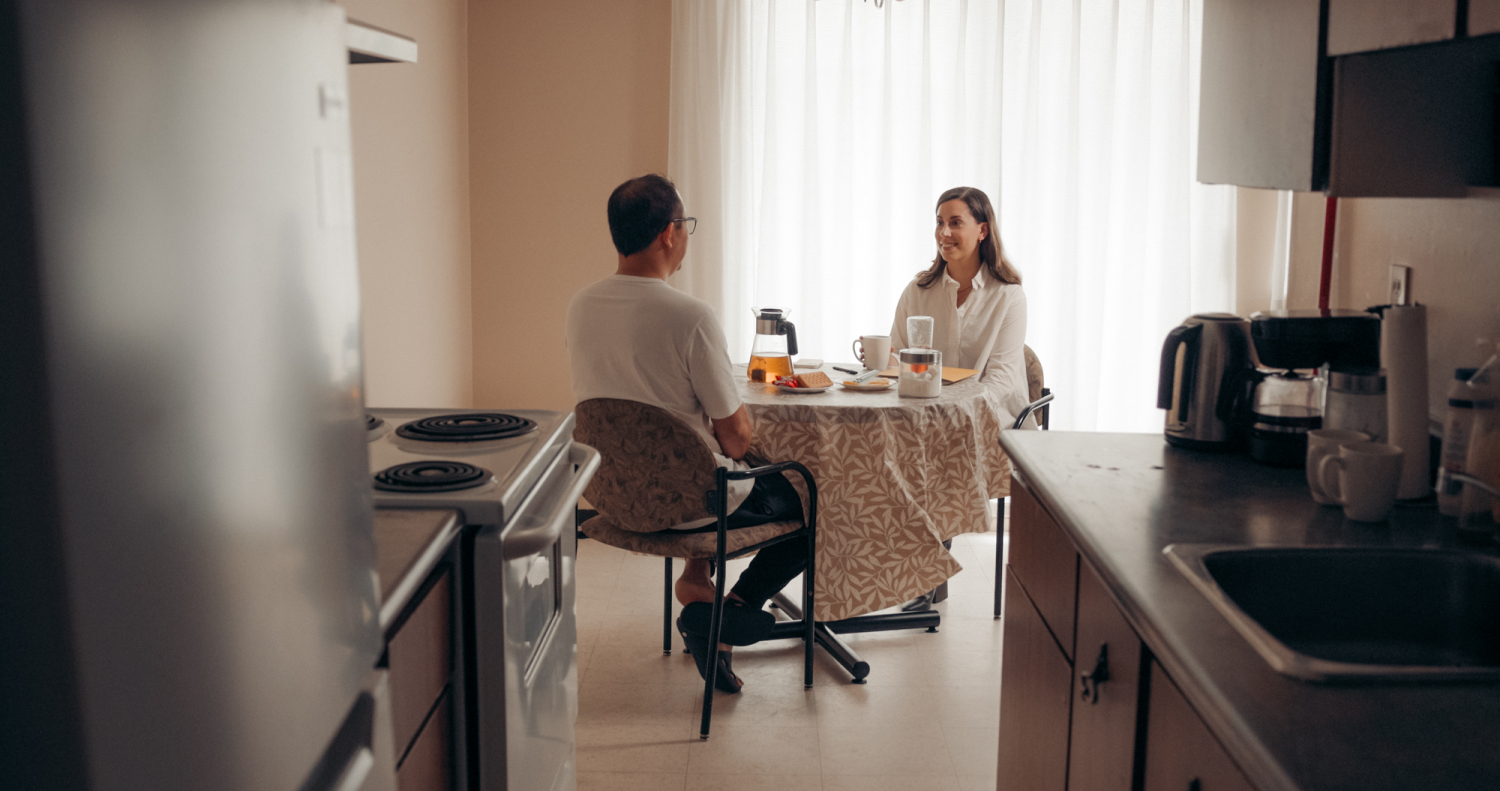 Two people sitting across a table from each other