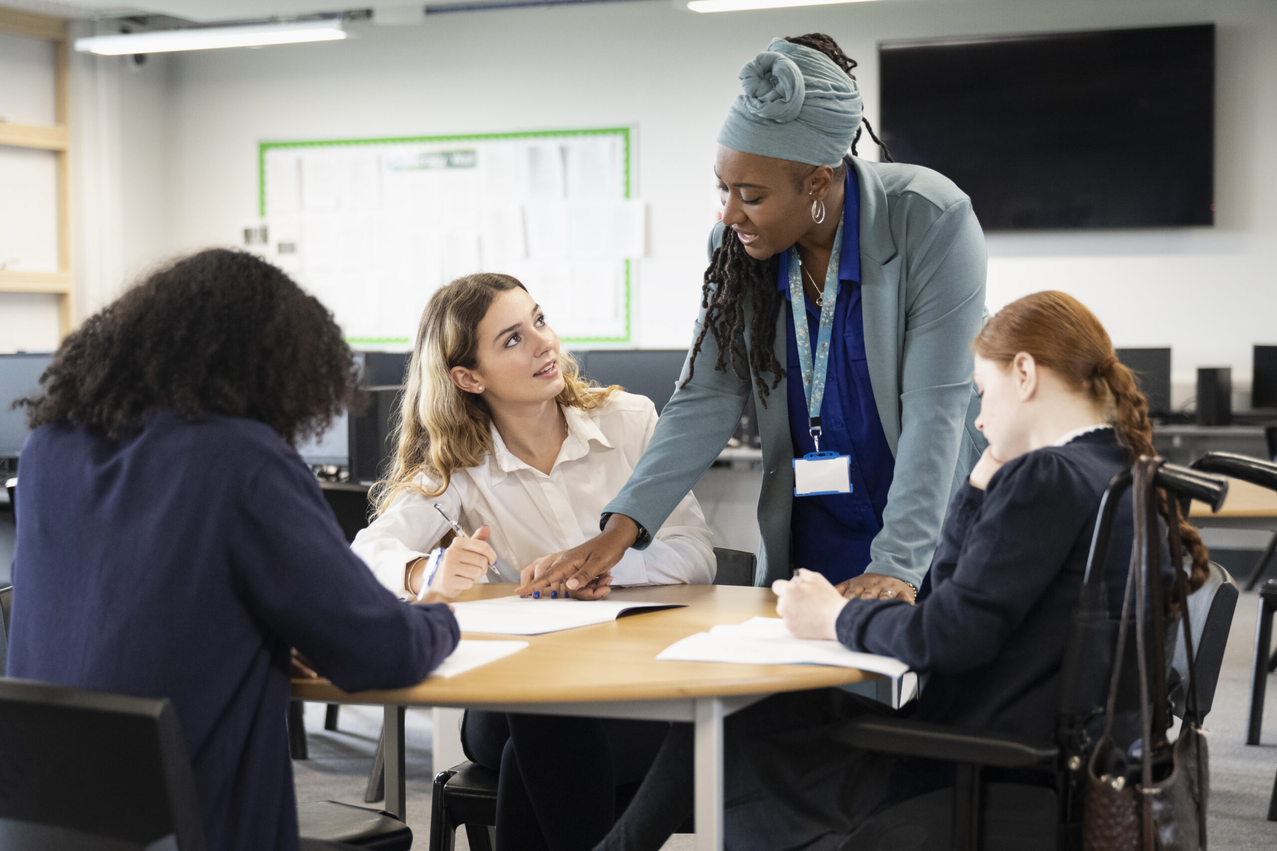 A diverse group of women sitting around a table in a discussion 