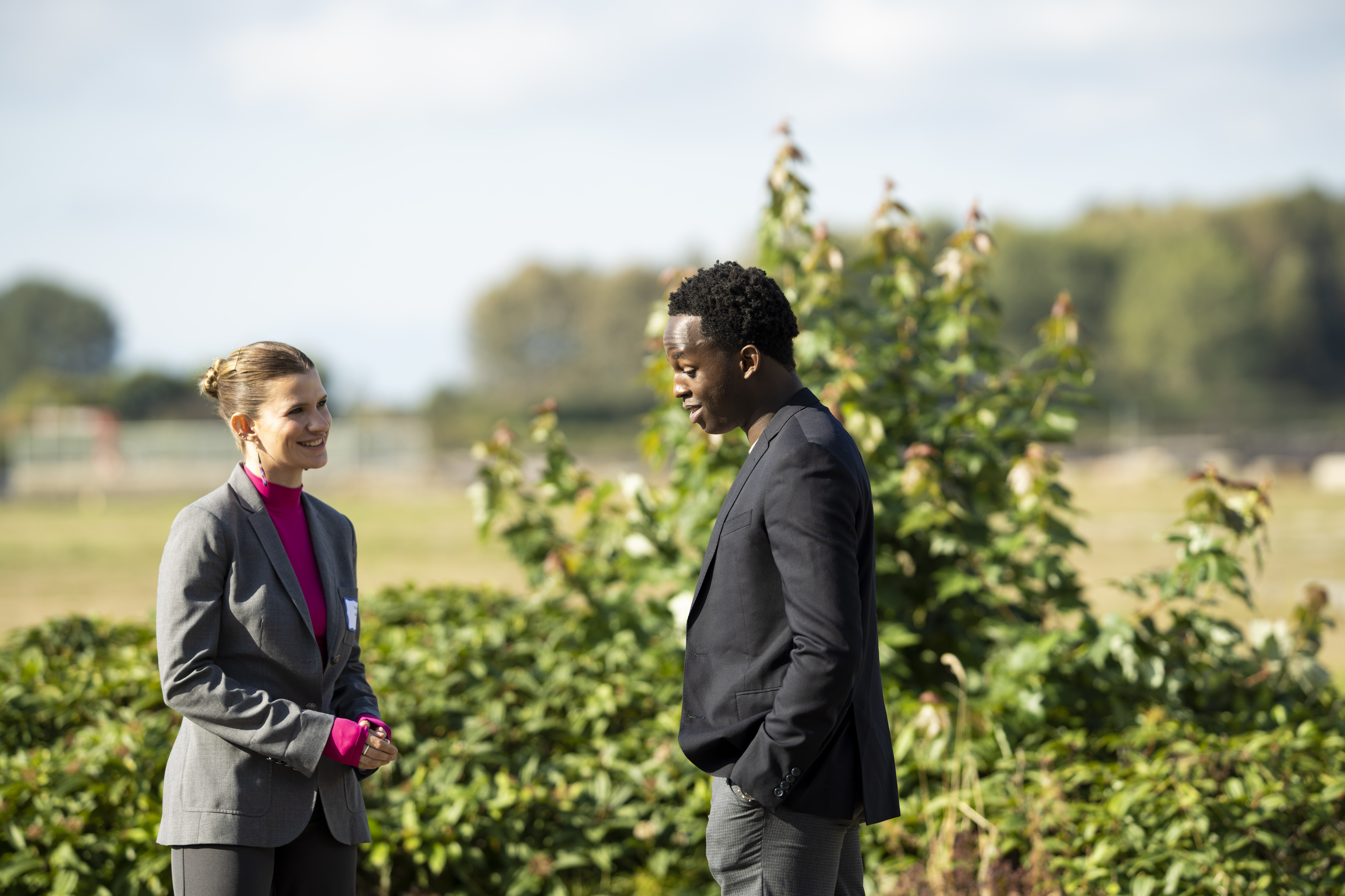 Vancouver Foundation – LEVEL Program Two participants chat while taking a break outside in the sun.