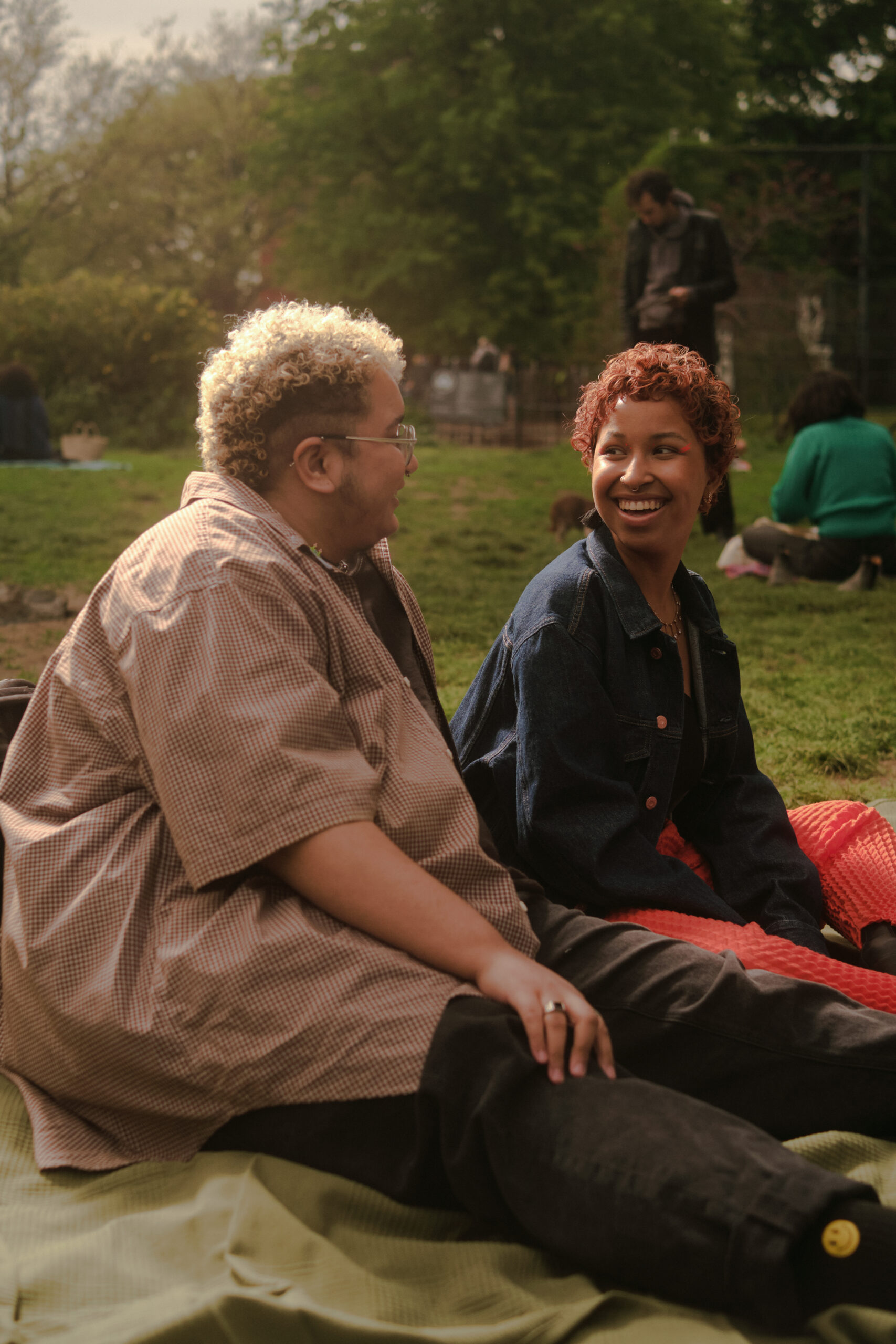 A trans couple sharing a moment in the park.