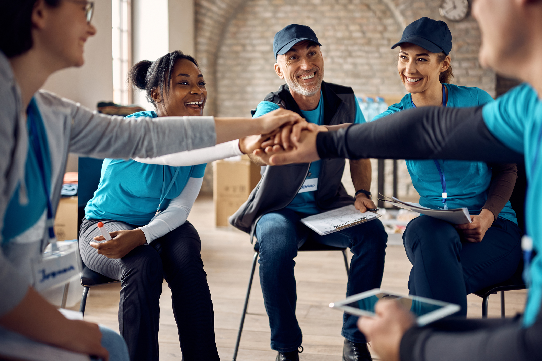 Team of volunteers gathering hands