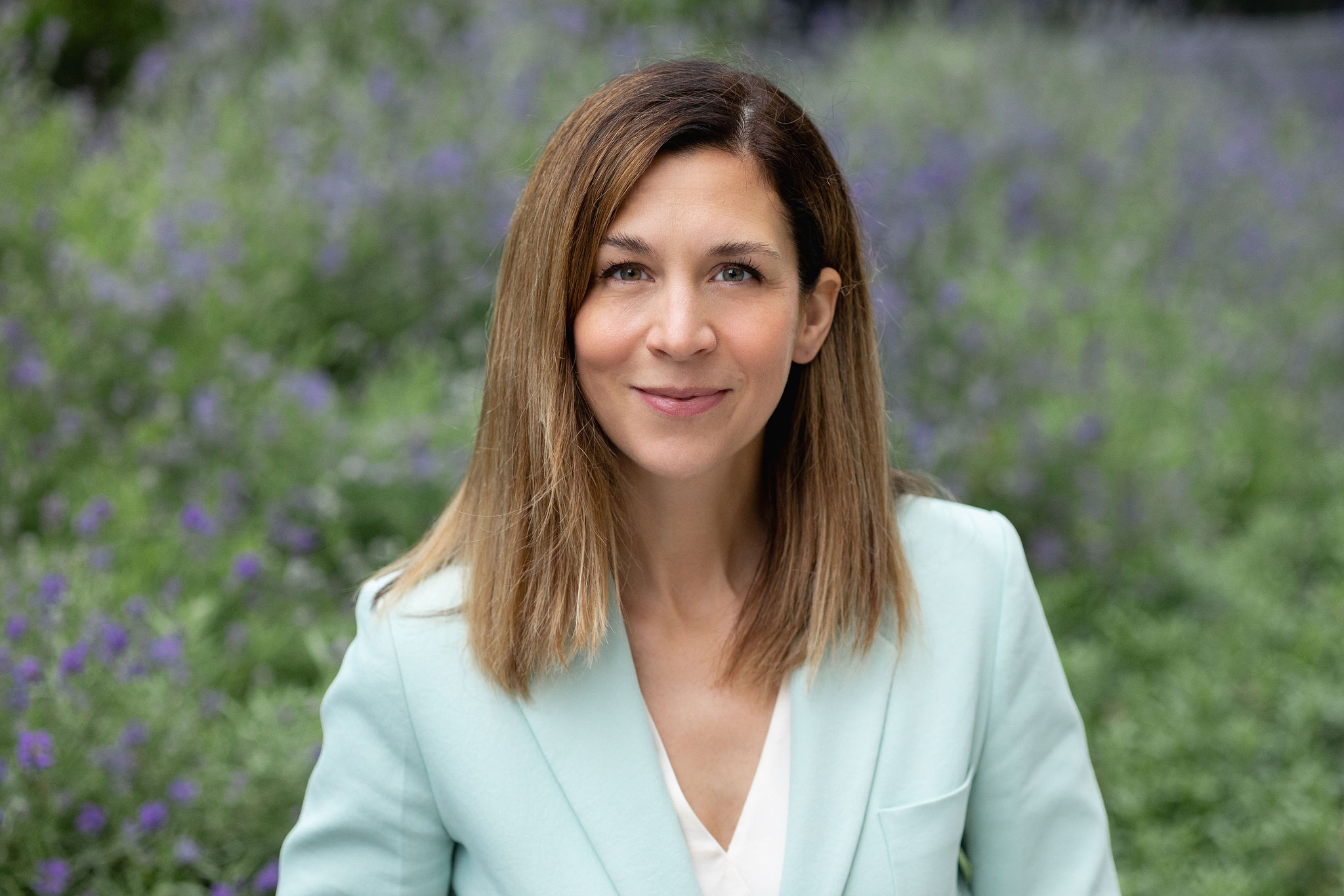 Headshot of Kate Hammer with a slight smile on her face. She has light brown hair and green eyes.