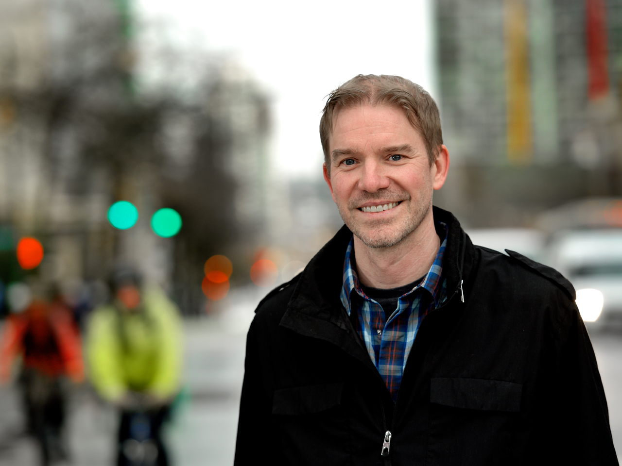 A picture of Derek Wills, a man with short light brown hair and light eyes, smiling