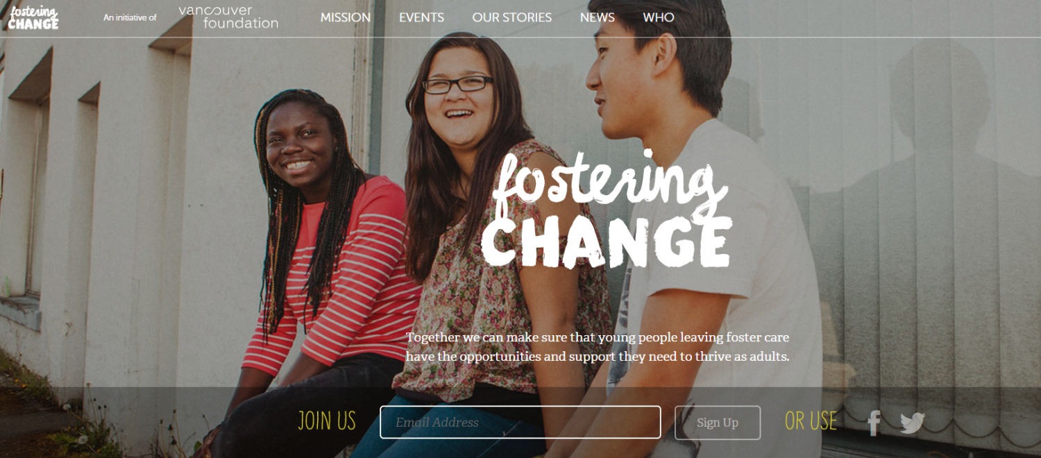 Three diverse youth sitting on an outside ledge on a building, smiling, with text reading "Fostering Change"