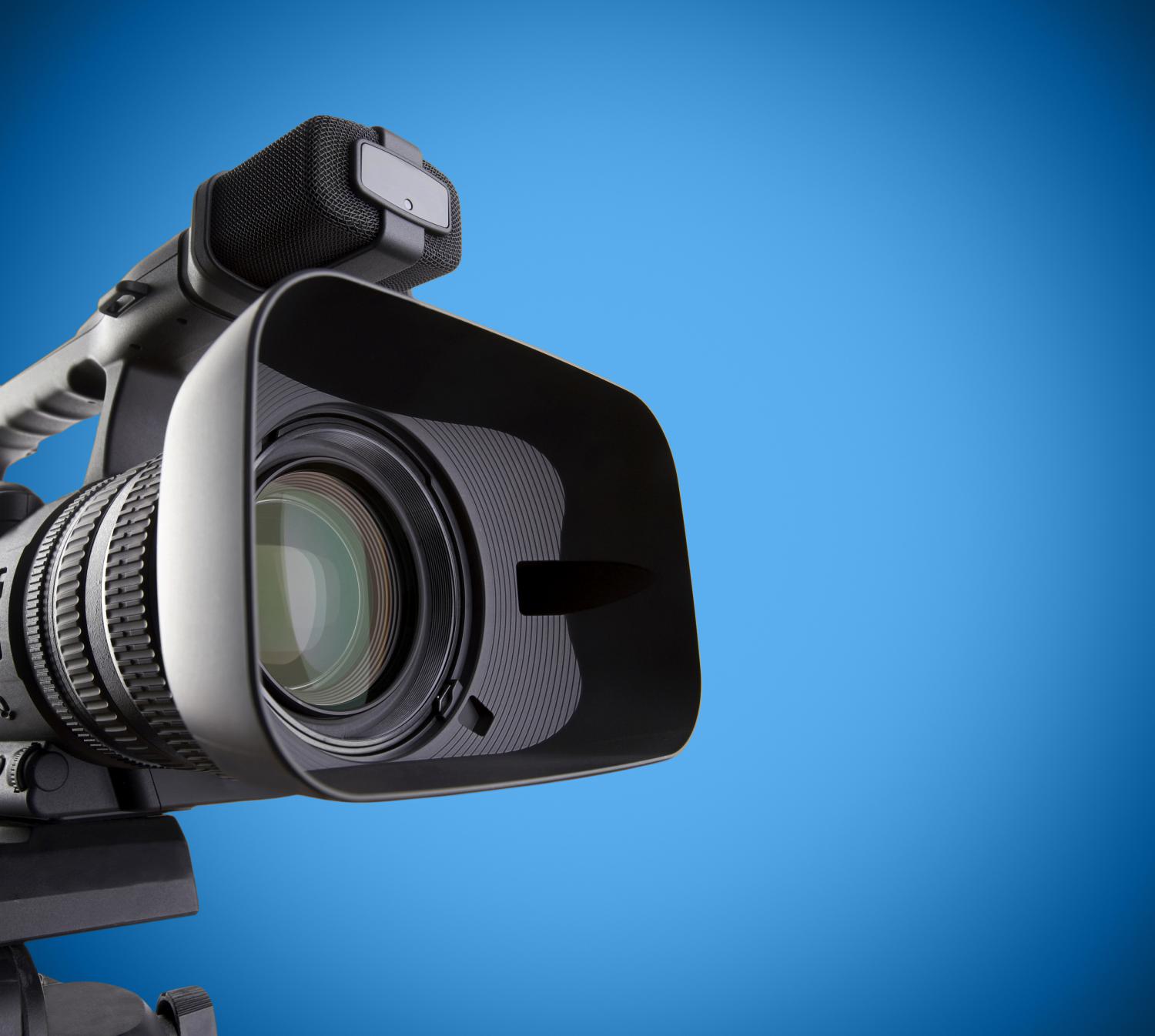 View of the lens of a professional news camera with microphone
