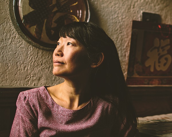 VF2019-14A_cmyk Side profile of an asian woman with long hair looking pensive